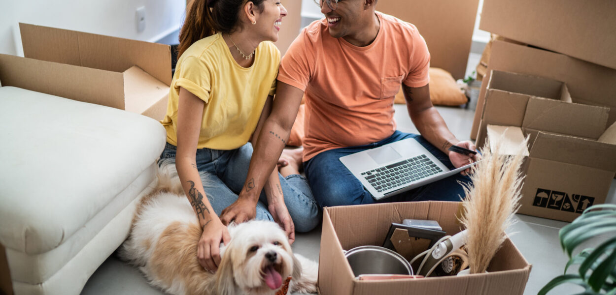 Young couple packing and moving boxes at home