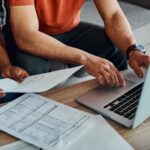 2 people filing taxes on a laptop