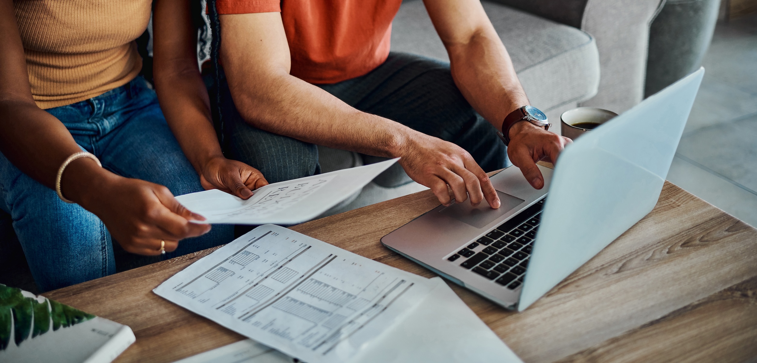 2 people filing taxes on a laptop